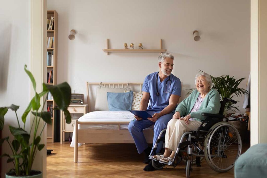 Older adult and family member reviewing assisted living information with a staff member in a bright common room.
